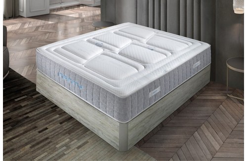 Colchón INFINITY blanco con canales de ventilación y base gris, diseño moderno para descanso superior