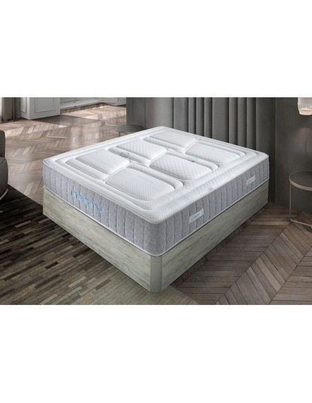 Colchón INFINITY blanco con canales de ventilación y base gris, diseño moderno para descanso superior