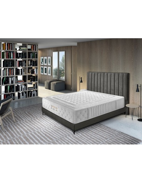 Colchón Legend blanco con base gris oscuro en dormitorio moderno con cabecero tapizado